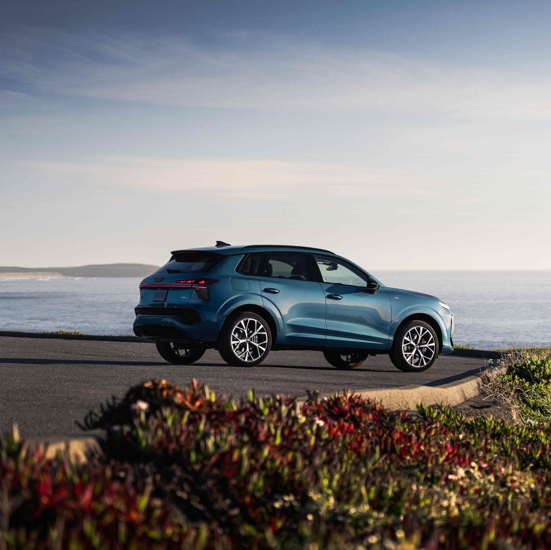 Rear profile view of an Audi Q3 parked.